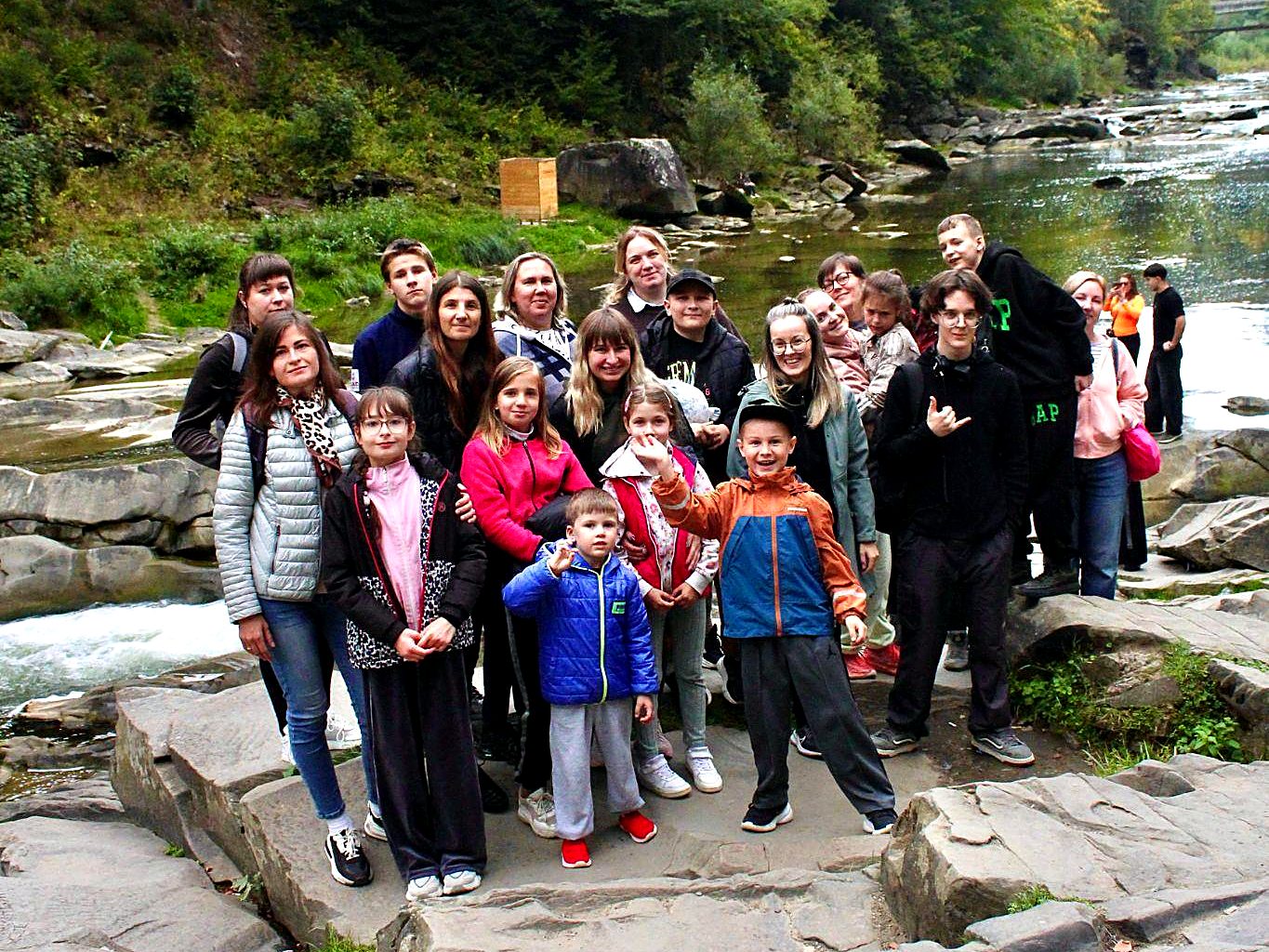 Retreat participants gathered together by the river in Yaremche